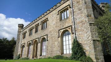 A historic stone building with arched windows and a symmetrical facade.