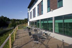 A modern building with a wooden deck, outdoor seating, and large windows. - Holiday Inn Express Hotel Burnley M65 JCT10 by IHG (Burnley)