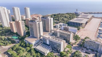 A high-rise building complex with multiple floors, a central plaza, and a waterfront view.