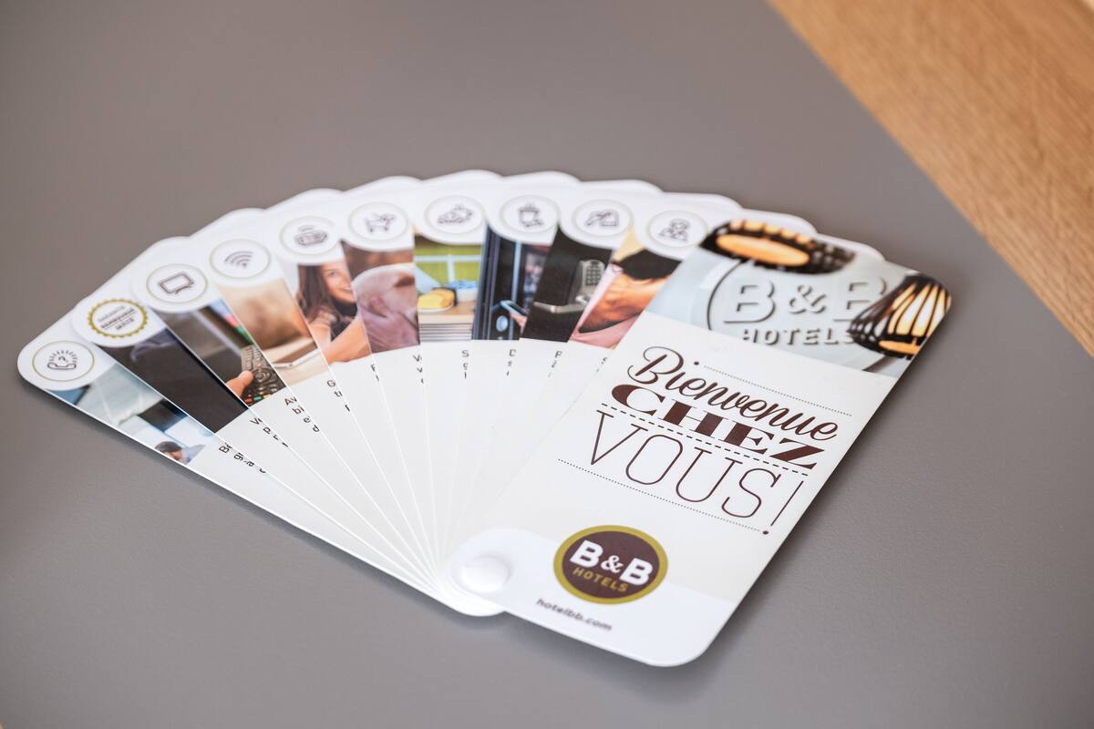 A fan of B&B Hotels' welcome cards with various amenities and room features.