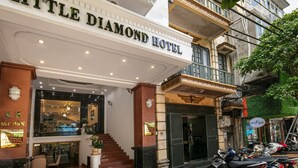 The exterior of the Little Diamond Hotel with a grand entrance, a staircase leading to the lobby, and a visible sign for the spa. - Little Diamond Hotel (Hanoi)