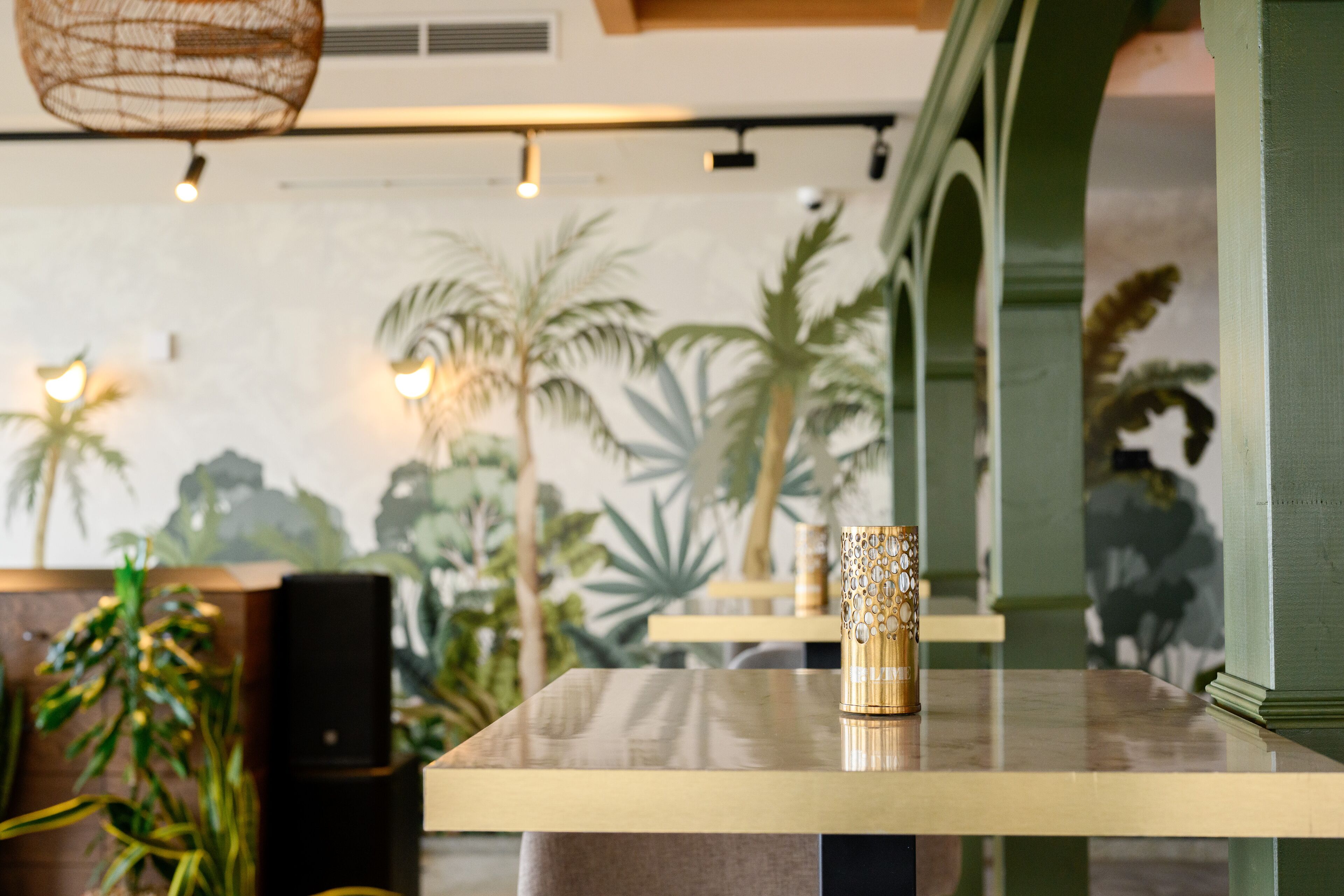 Un interno ristorante con un tavolo, un vaso decorativo e un altoparlante.