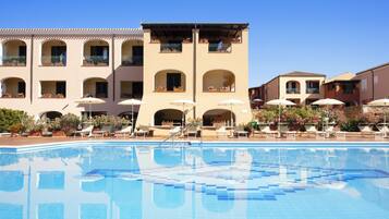 Een buitenzwembad, parasols voor strand/zwembad