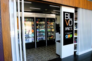 A self-checkout market area with three beverage vending machines and a sign for 'BLVD MKT. powered by grabscango'. - BLVD Hotel and Studios Universal-Hollywood, an Ascend Collection Hotel (Studio City)