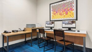 A modern office space with two desks, chairs, a printer, and a large abstract art piece on the wall. - Holiday Inn Express & Suites Klamath Falls Central by IHG (Klamath Falls)