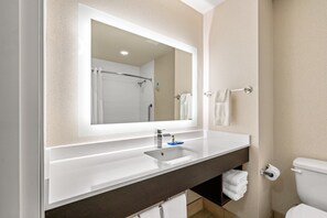 A modern bathroom with a white sink, a large mirror, and a toilet. - Holiday Inn Express & Suites Klamath Falls Central by IHG (Klamath Falls)