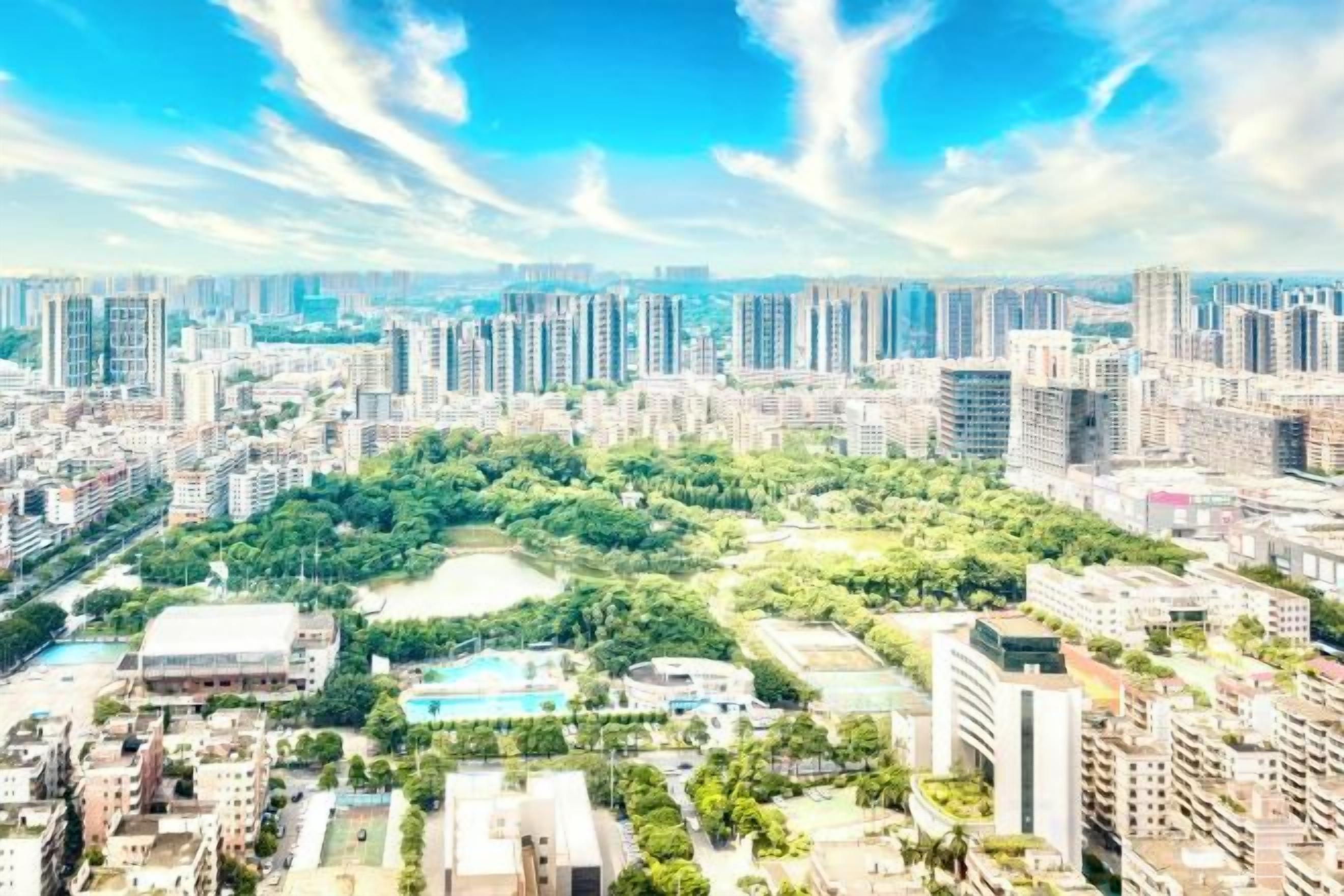 A high-rise urban area with dense residential buildings, a central green park, and a clear sky.