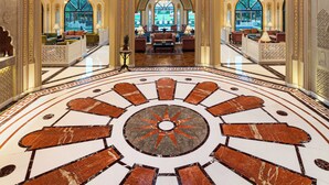 A grand lobby with a large chandelier, ornate ceiling, and a central circular floor design. - Heritage Village Resort & Spa Manesar (Gurugram)