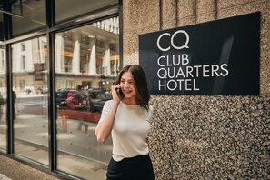 A sign for CQ Club Quarters Hotel.