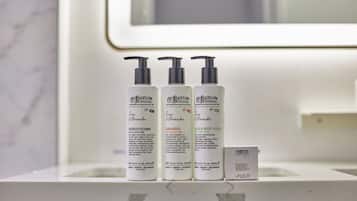 Three bottles of Rigelow products on a bathroom counter.