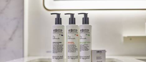 Three bottles of Rigelow products on a bathroom counter.