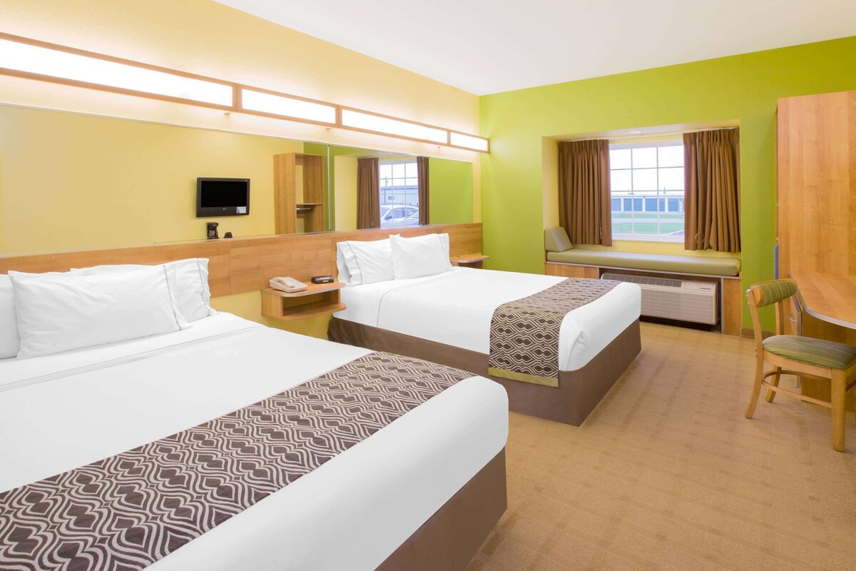 Hypo-allergenic bedding, desk, laptop workspace, blackout curtains
