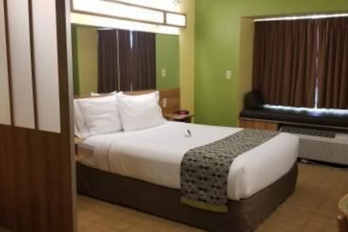 Hypo-allergenic bedding, desk, laptop workspace, blackout curtains