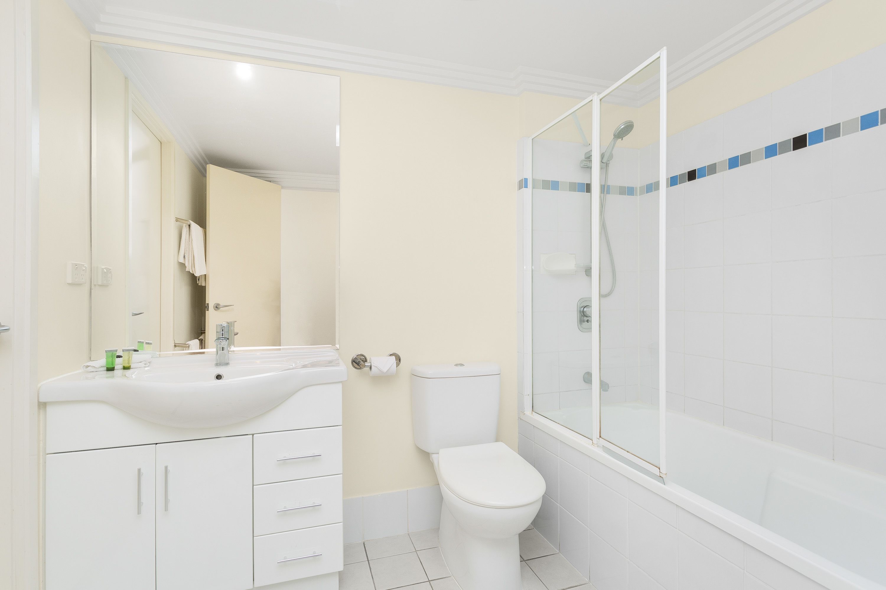 A bathroom with a sink, toilet, and shower.