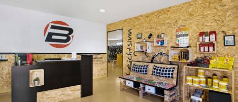 A reception area with a wooden wall, a reception desk, and various informational displays.