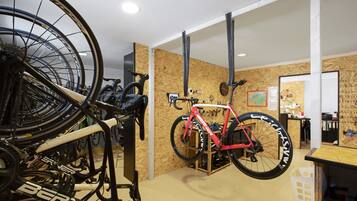 A room with bicycles, a wooden wall, and a whiteboard.