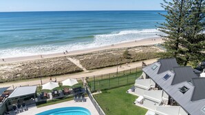A pool area with a view of the beach and ocean. - The Breakers (Surfers Paradise)