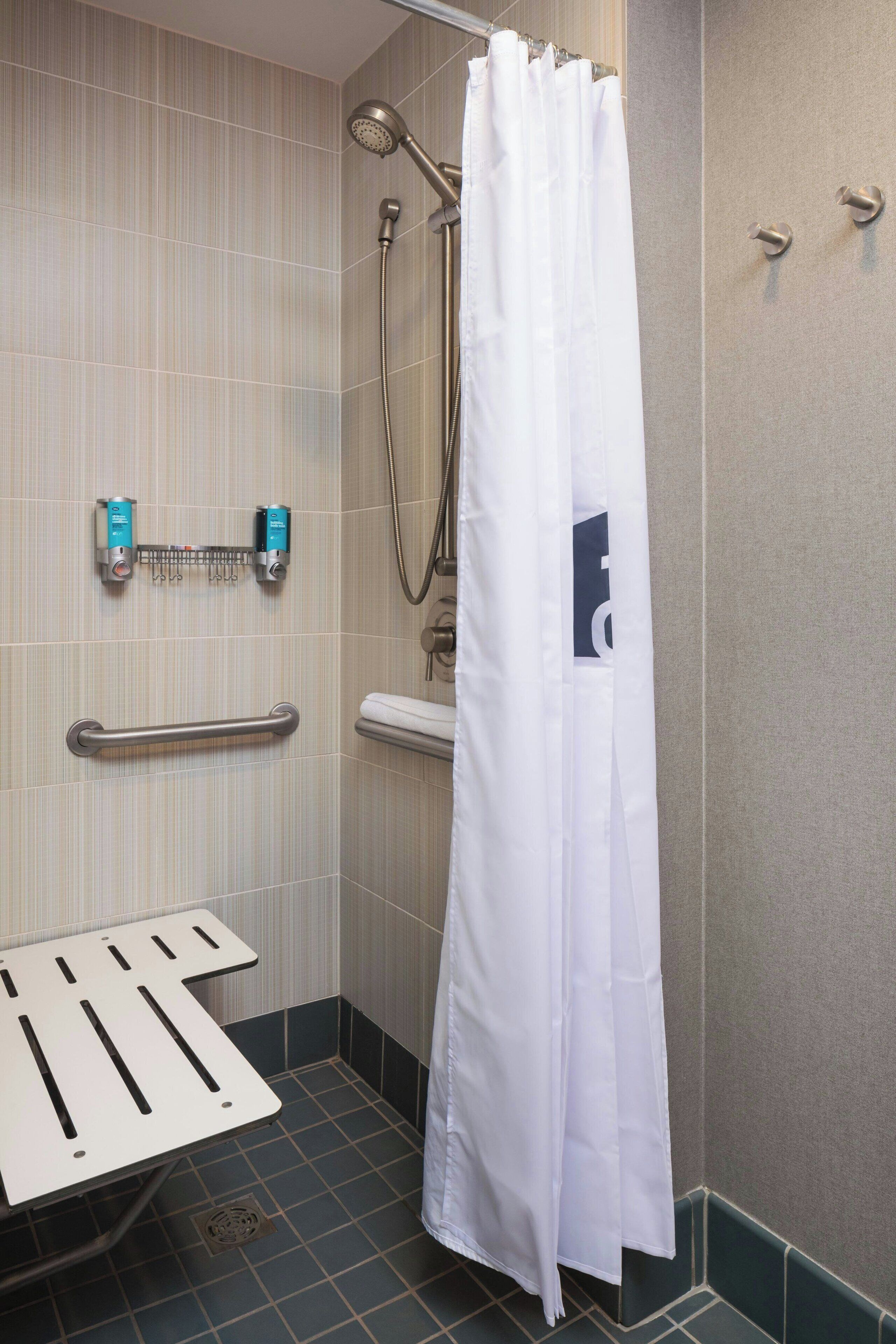 shower, designer toiletries, hair dryer, towels