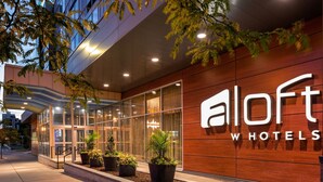 A modern hotel entrance with a large sign reading "aloft hotels". - Aloft by Marriott Minneapolis (Minneapolis)