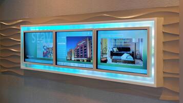 A digital display with three screens showing hotel information.