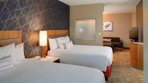 A hotel room with two beds, a TV, a desk, and a sofa. - SpringHill Suites St. Louis Brentwood (Brentwood)