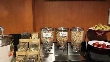 A breakfast bar with various food dispensers, including cereal and granola.
