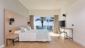 A modern hotel room with a large bed, a desk, a TV, and a view of the ocean. - Hotel HSM Golden Playa (Palma de Mallorca)