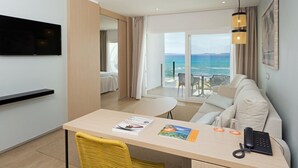 A hotel room with a balcony, a dining area, a TV, and a phone. - Hotel HSM Golden Playa (Palma de Mallorca)