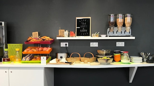 A buffet setup with various food items and condiments.