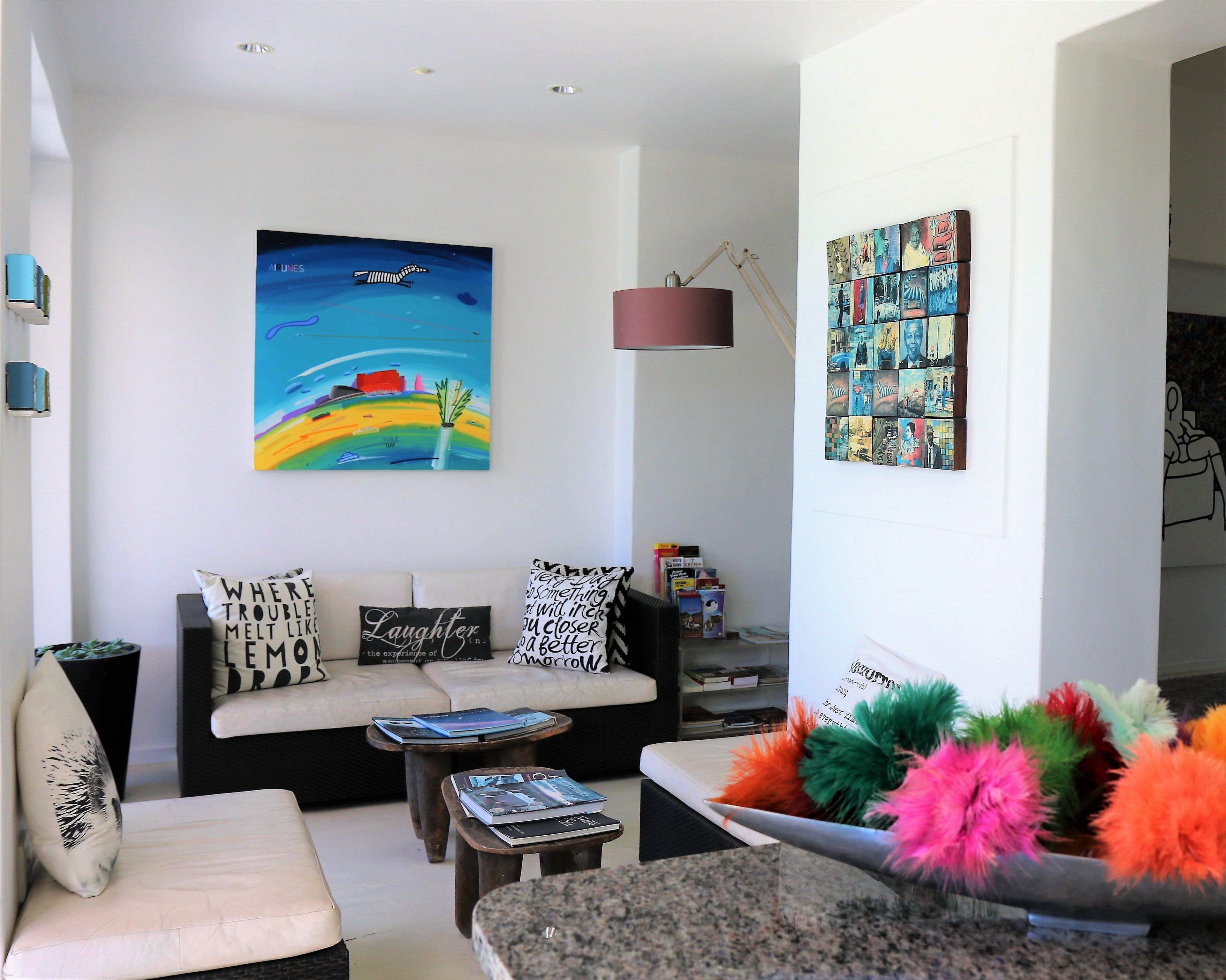 A modern living room with a sofa, coffee table, and colorful pillows.
