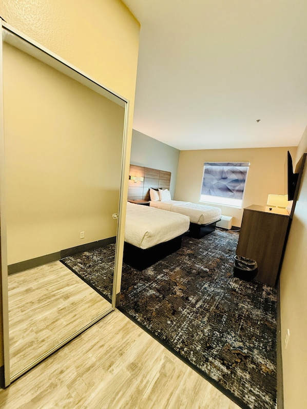 Premium bedding, desk, laptop workspace, blackout drapes