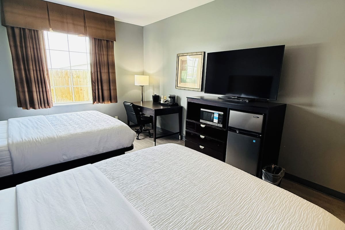 Premium bedding, desk, laptop workspace, blackout drapes