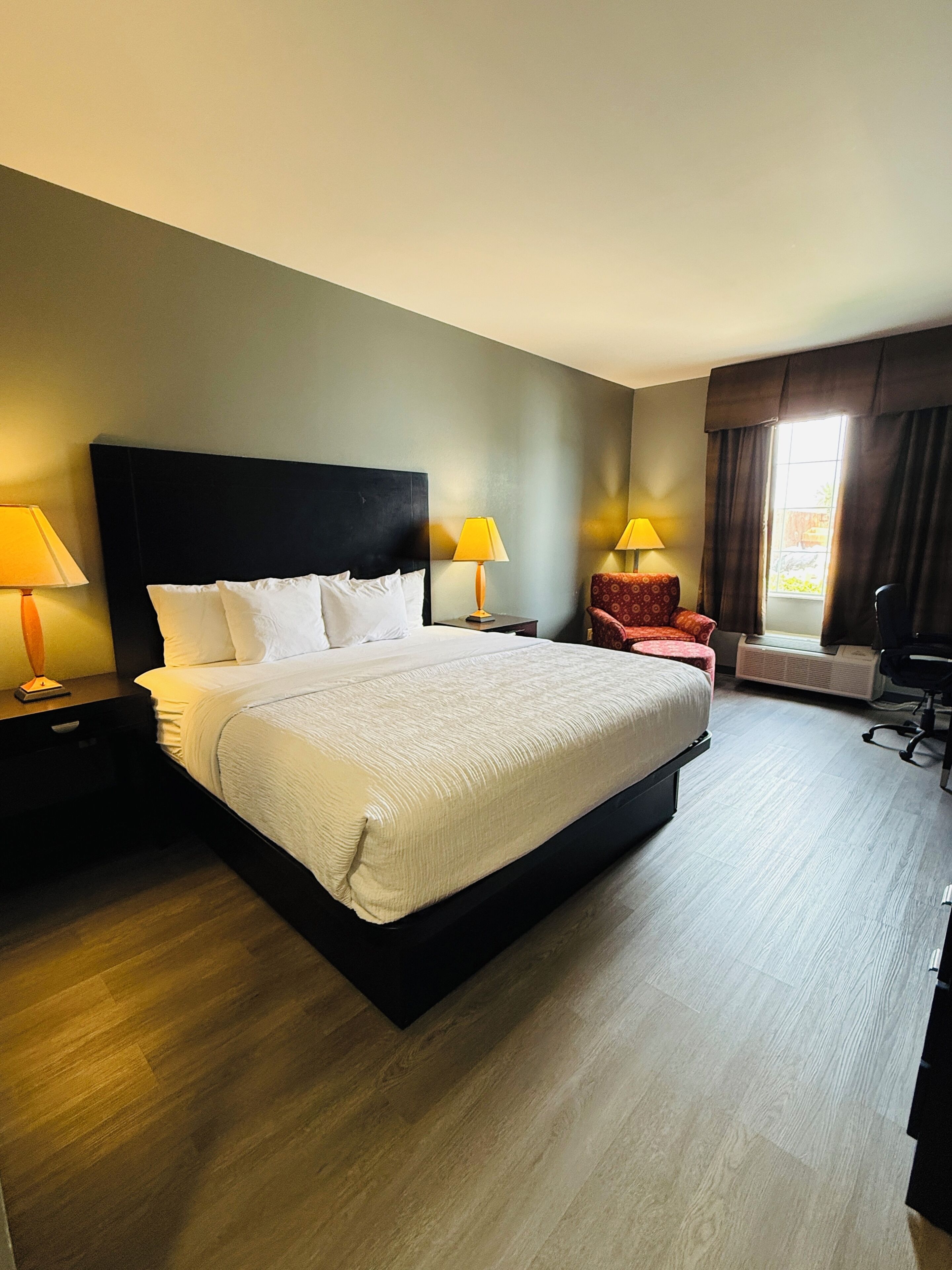 Premium bedding, desk, laptop workspace, blackout drapes