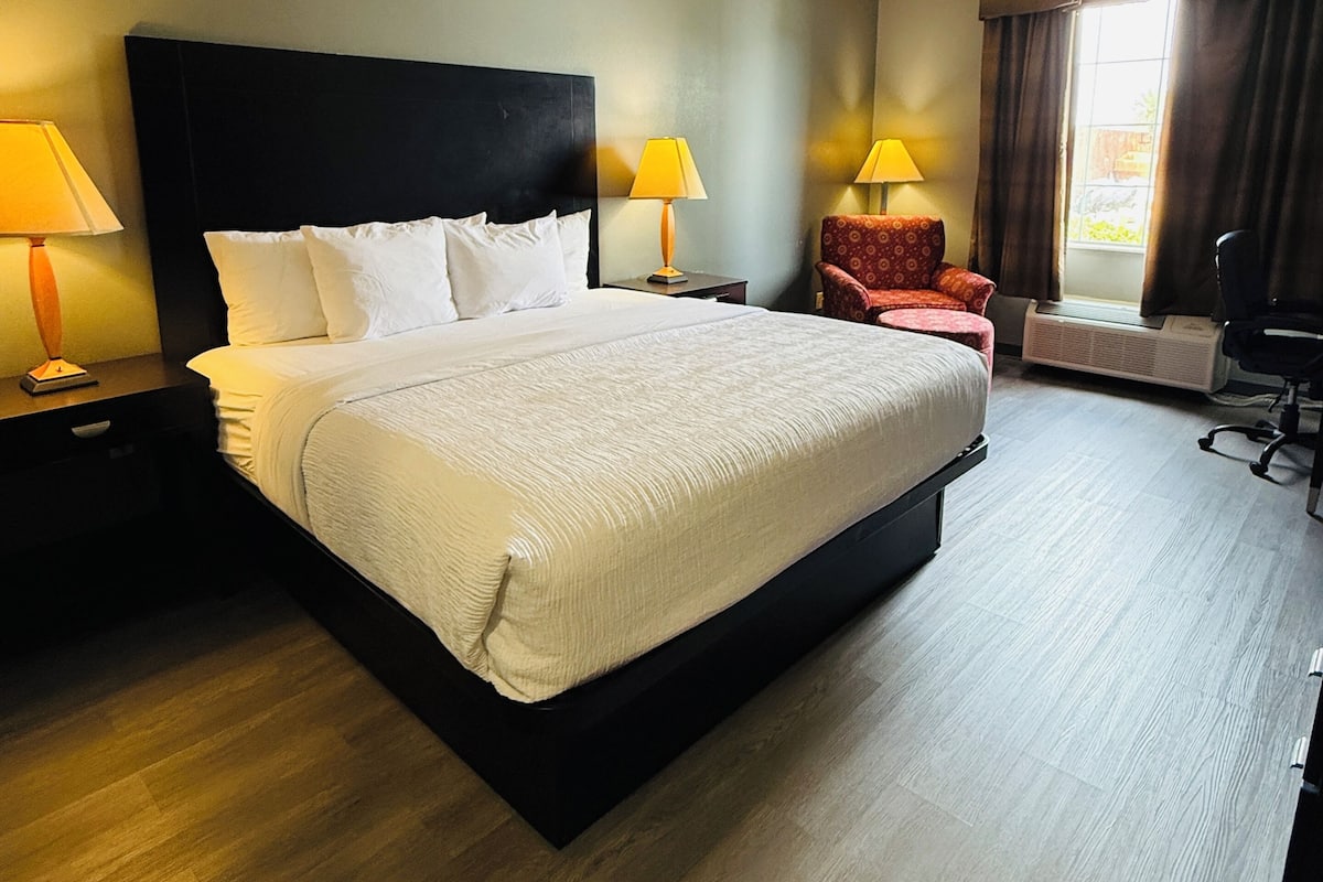 Premium bedding, desk, laptop workspace, blackout drapes