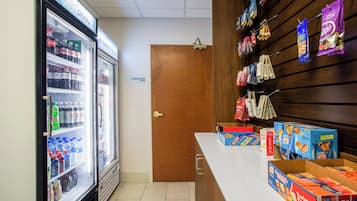 A vending area with snacks and a refrigerator stocked with beverages.