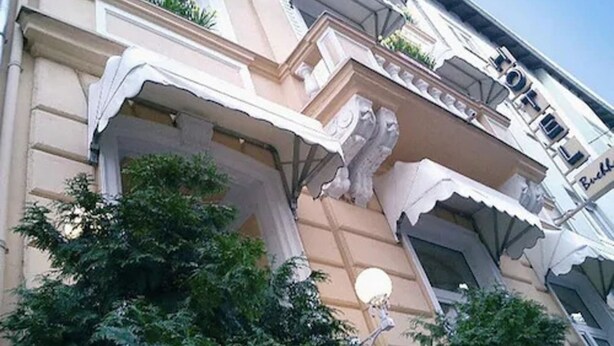A building with ornate architectural details, including a balcony with decorative railings and a sign that reads "TOFEL". - Buchholz Downtown Hotel (Cologne)