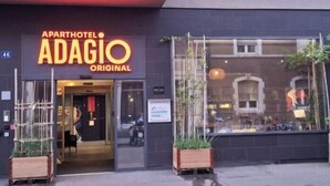 An apartment hotel named Adagio Original with a modern facade, large windows, and potted plants at the entrance. - Aparthotel Adagio Basel City (Basel)