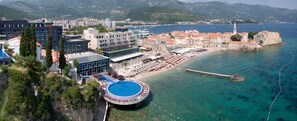 A coastal hotel with a pool, beach area, and views of the sea and mountains. - Avala Resort & Villas (Budva)