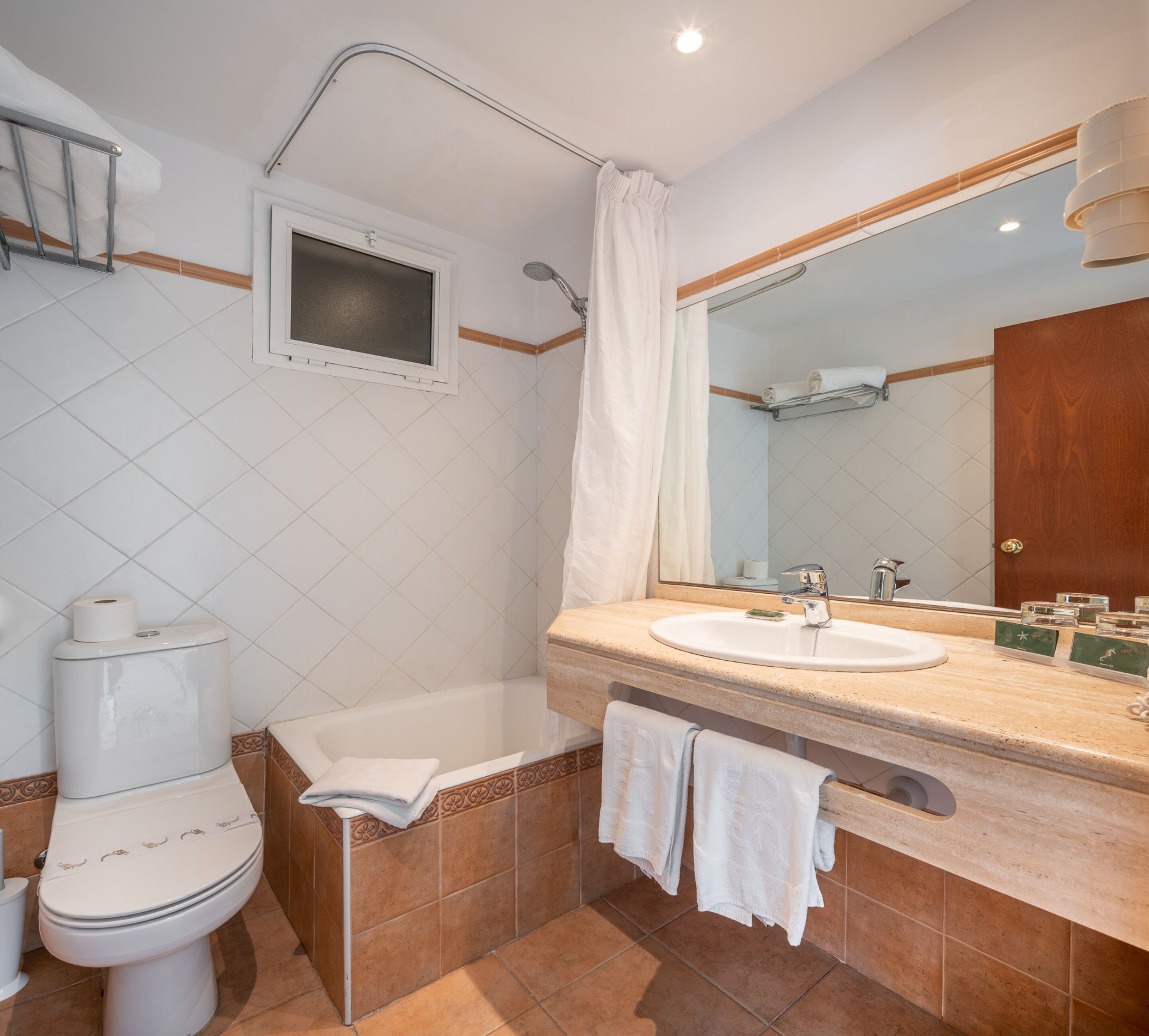 bathtub, hair dryer, towels, soap