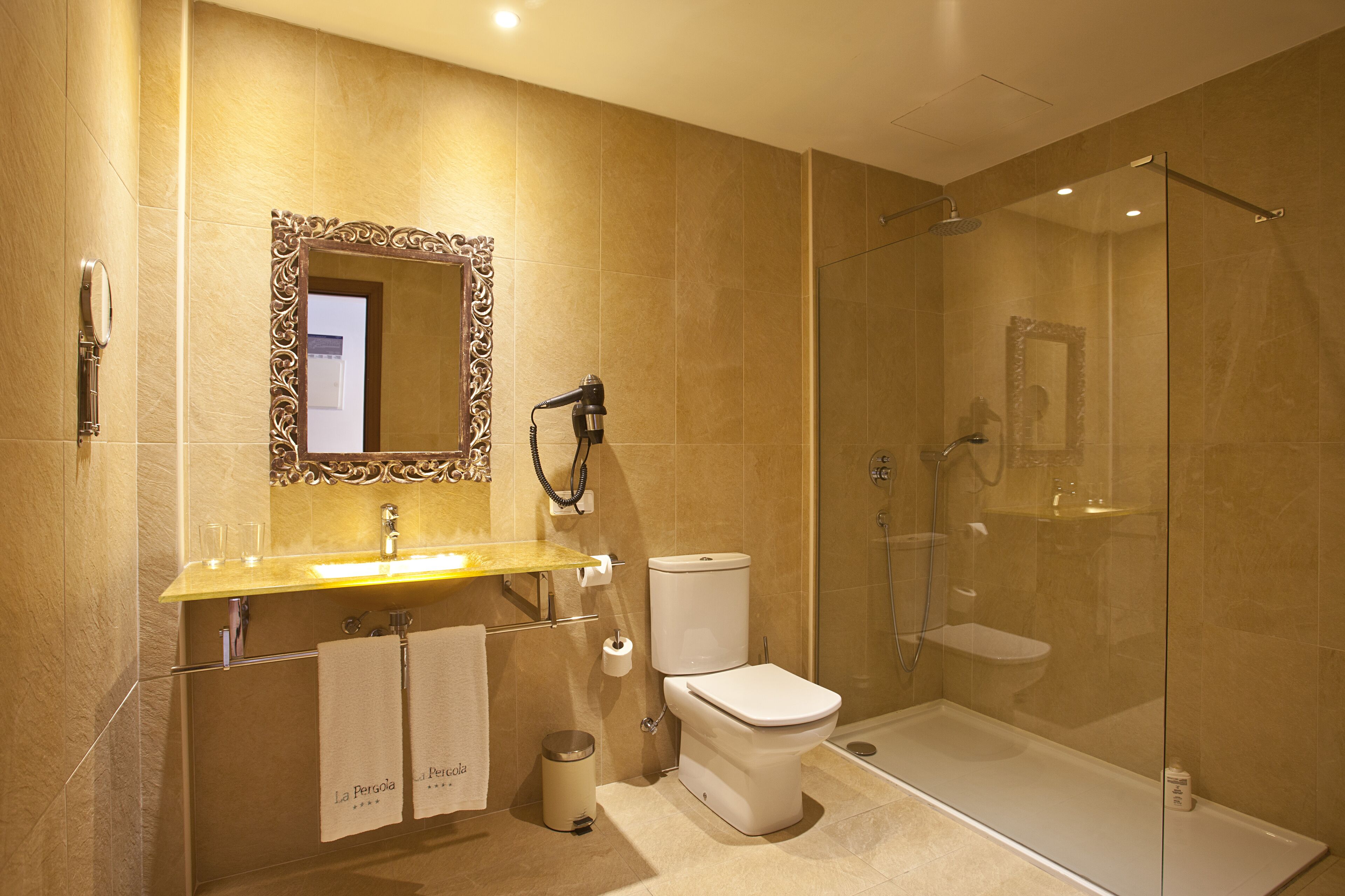 A modern bathroom with a glass-enclosed shower, a vanity with a mirror, and a toilet.