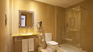 A modern bathroom with a glass-enclosed shower, a vanity with a mirror, and a toilet.