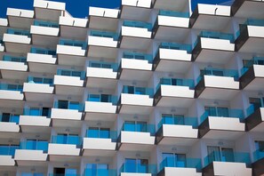 Un edificio moderno con un patrón repetitivo de balcones y ventanas.