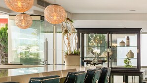 A modern hotel lobby with a glass partition, a reception desk, and seating area. - Tomir Portals Suites - Adults Only (+16) (Calvia)
