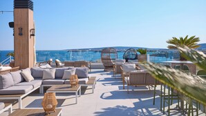 A rooftop terrace with seating, a tall tower, and a view of the sea. - Tomir Portals Suites - Adults Only (+16) (Calvia)