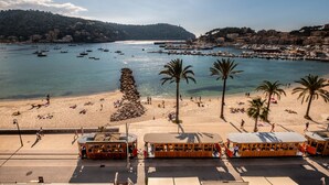 A coastal town with a beach, boats, and a tram system.