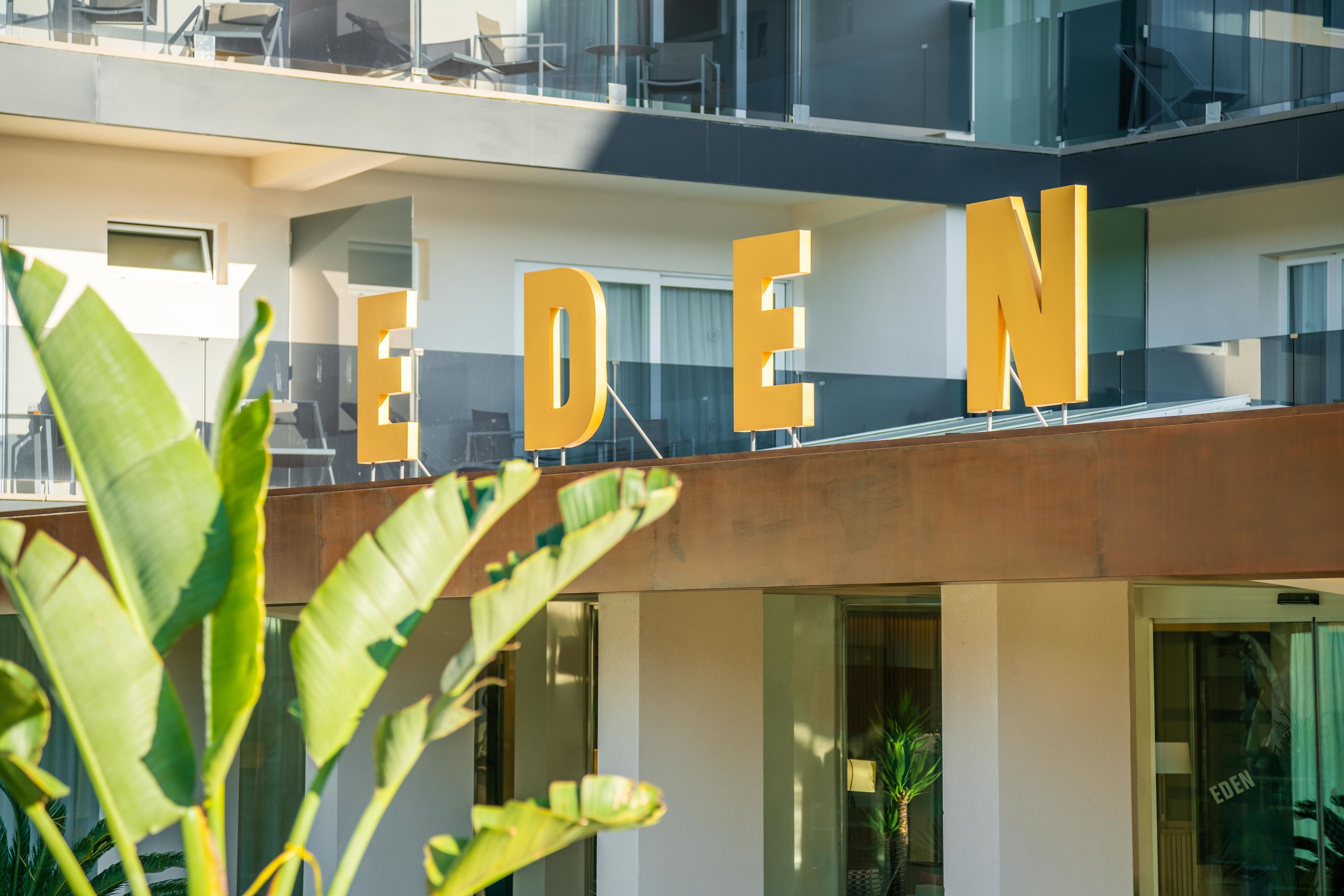 A building with large, bold letters spelling "EDEN" on the facade.