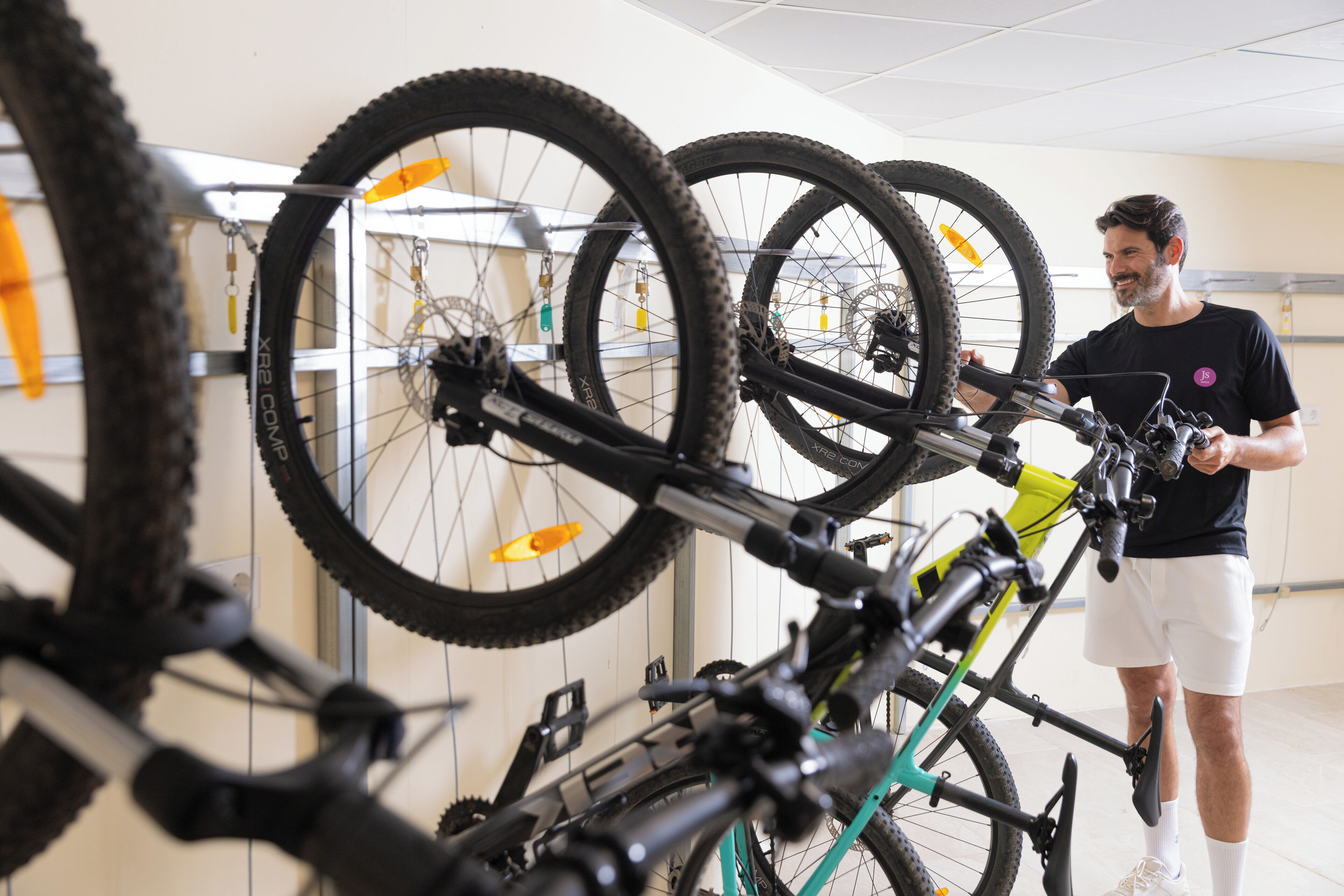 A bicycle repair station with multiple bikes and a person working on a bike.
