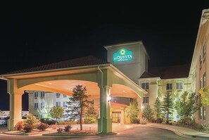 A hotel entrance with a covered parking area, a sign for La Quinta Inn & Suites, and a building with multiple windows. - La Quinta Inn & Suites by Wyndham Trinidad (Trinidad)