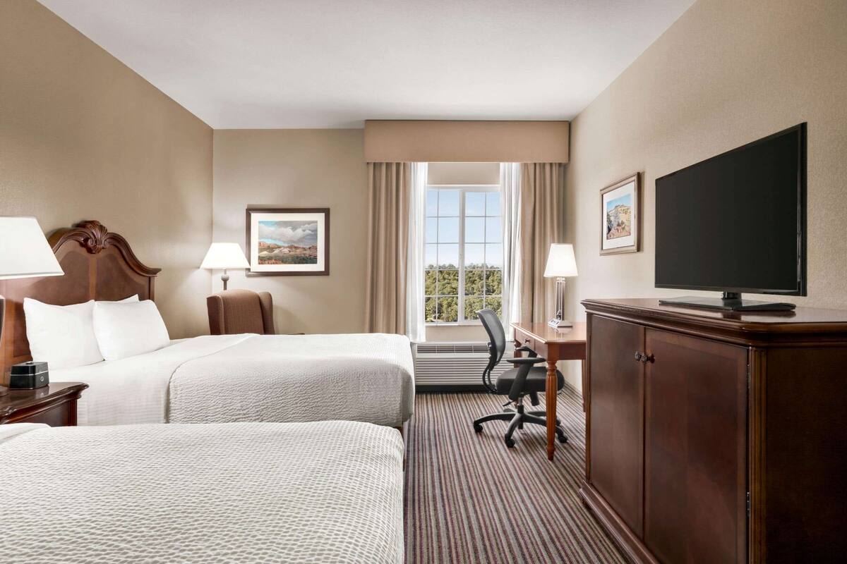 deluxe suite, 2 queen beds, non smoking | premium bedding, desk, iron/ironing board, free cots/infant beds