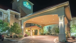 A hotel entrance with a covered driveway, a sign reading "LAQUINTA Inn & Suites," and a well-lit facade. - La Quinta Inn & Suites by Wyndham Trinidad (Trinidad)